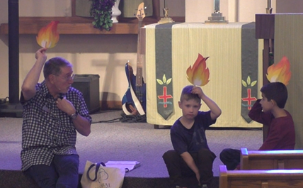Children's sermon depicting the flames that rested above the heads of the disciples and symbolizing the arrival of the Holy Spirit.